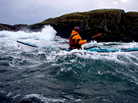 Image of a Kayaker in stormy seas.